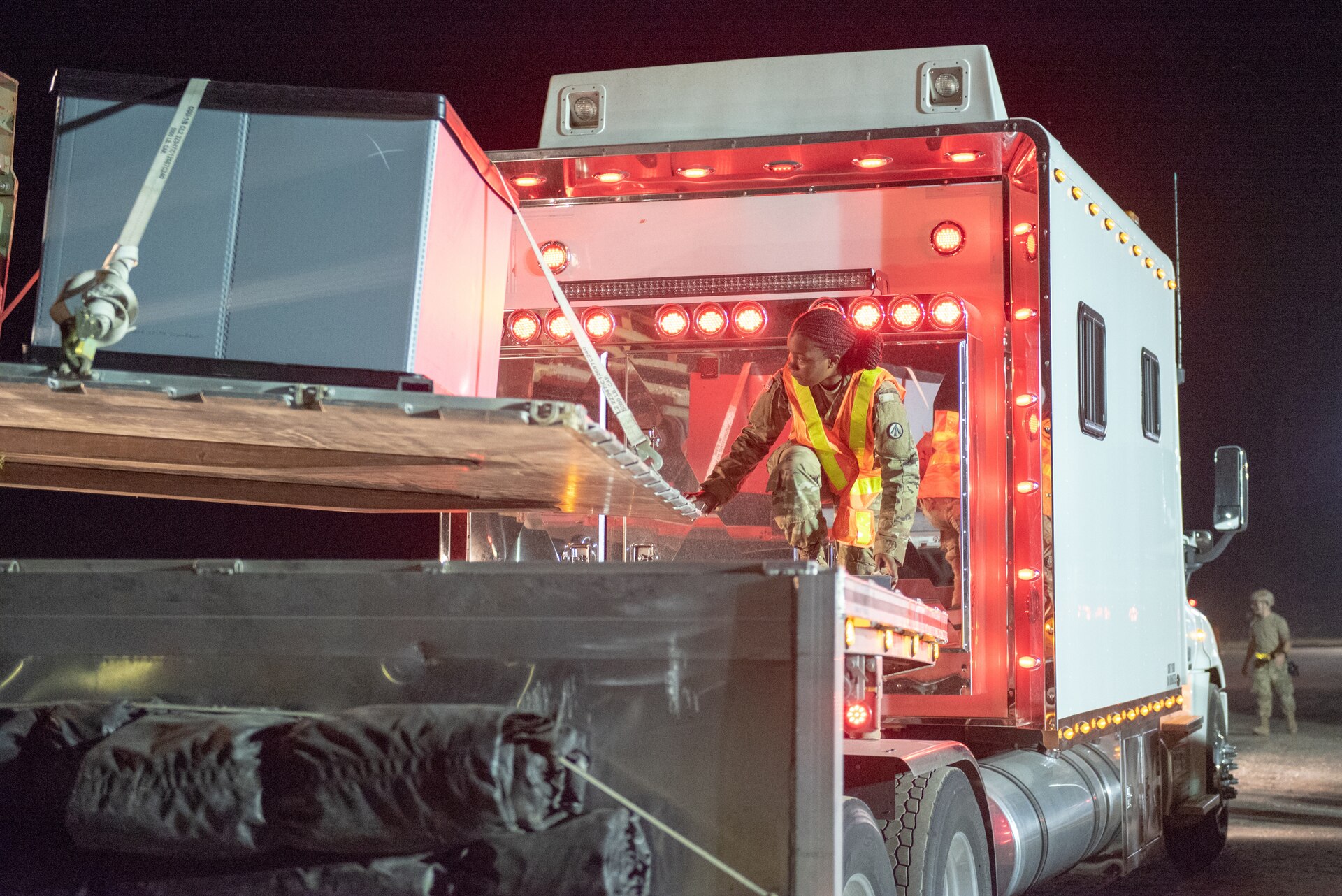 U.S. Army Pfc. Jakiya Peele, a cargo handling specialist with the 690th Rapid Port Opening Element, guides cargo onto a truck during Operation Lone Oak at Volk Field, Wis., June 10, 2021. The RPOE worked in conjunction with the Kentucky Air National Guard’s 123rd Contingency Response Group to operate a Joint Task Force-Port Opening during the exercise. The objective of a JTF-PO is to establish a complete air logistics hub and surface distribution network. (U.S. Air National Guard photo by Senior Master Sgt. Vicky Spesard)