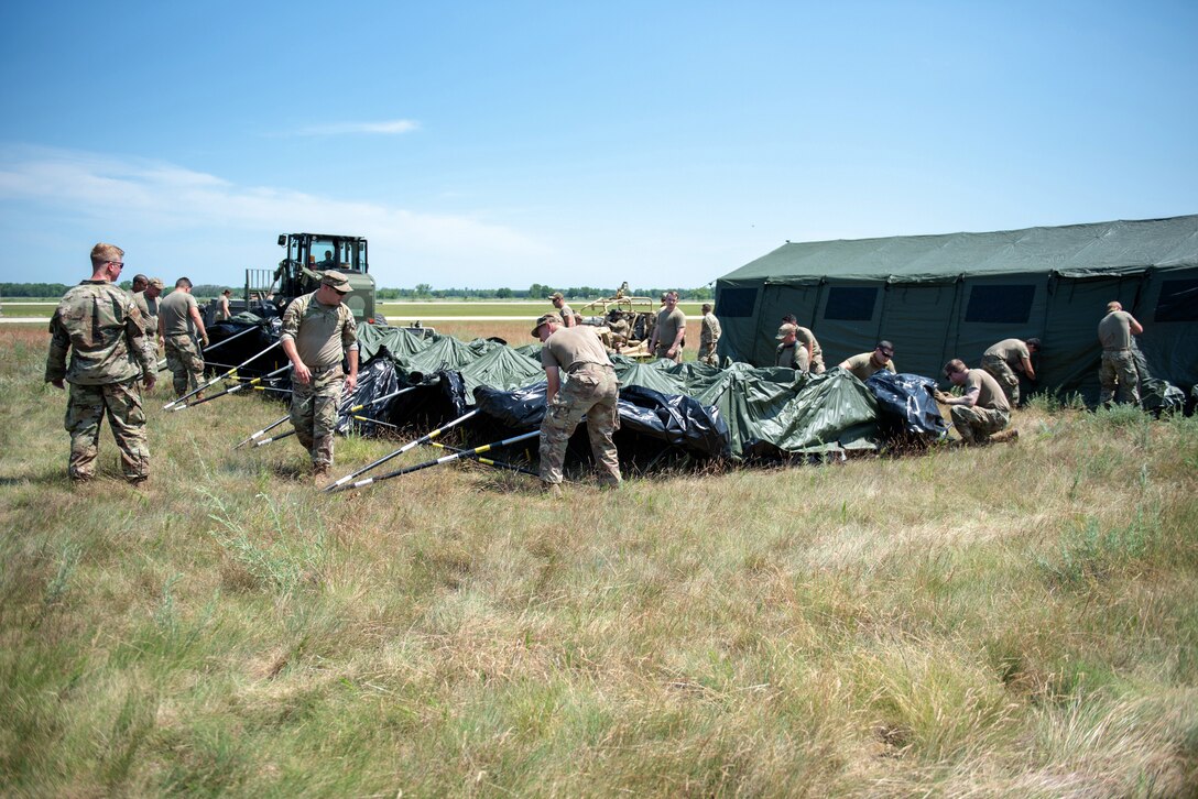 Airmen from the Kentucky Air National Guard’s 123rd Contingency Response Group set up their base of operations for a Joint Task Force-Port Opening exercise known as Operation Lone Oak on June 7, 2021, at Volk Field, Wis. The objective of a JTF-PO is to establish a complete air logistics hub and surface distribution network from scratch. (U.S. Air National Guard photo by Senior Master Sgt. Vicky Spesard)