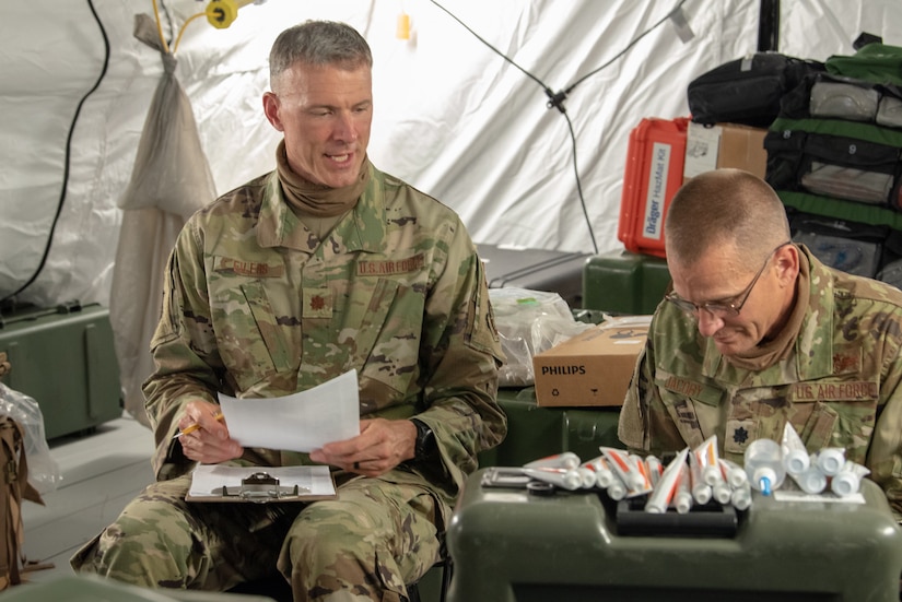 Maj. Kevin Eilers (left) assists Lt. Col. Darin Jacoby, 123rd Contingency Response Group medical flight commander, to inventory medical supplies during a Joint Task Force-Port Opening exercise known as Operation Lone Oak at Volk Field, Wis., June 11, 2021. Jacoby treated Airmen and Soldiers for a wide range of medical needs during the exercise. (U.S. Air National Guard photo by Senior Master Sgt. Vicky Spesard)