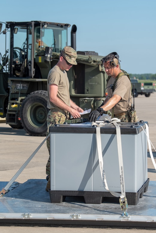 Staff Sgt. Jacob Land and Tech. Sgt. David Gomes, aerial porters from the Kentucky Air National Guard’s 123rd Contingency Response Group, track cargo movements during a Joint Task Force-Port Opening exercise known as Operation Lone Oak at Volk Field, Wis., June 11, 2021. The movement was part of everyday operations during the JFT-PO exercise, which combined the efforts of the CRG with the U.S. Army’s 690th Rapid Port Opening Element from Fort Eustis, Va. The objective of a JTF-PO is to establish a complete air logistics hub and surface distribution network. (U.S. Air National Guard photo by Senior Master Sgt. Vicky Spesard)