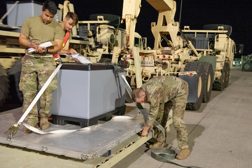 Aerial porters from the Kentucky Air National Guard’s 123rd Contingency Response Group and movement specialists with the U.S. Army’s 690th Rapid Port Opening Element from Fort Eustis, Va., secure cargo during a Joint Task Force-Port Opening exercise known as Operation Lone Oak at Volk Field, Wis., June 11, 2021. The objective of a JTF-PO is to establish a complete air logistics hub and surface distribution network. (U.S. Air National Guard photo by Senior Master Sgt. Vicky Spesard)