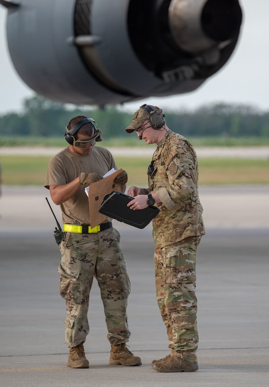 Aerial porters from the Kentucky Air National Guard’s 123rd Contingency Response Group prepare to offload cargo from an aircraft at Volk Field, Wis., June 11, 2021, as part of a Joint Task Force-Port Opening supporting Operation Lone Oak. The aircraft, from the Alaska Air National Guard, delivered trucks, supplies and personnel who were taking part in the Patriot North 21 exercise here. (U.S. Air National Guard photo by Senior Master Sgt. Vicky Spesard)