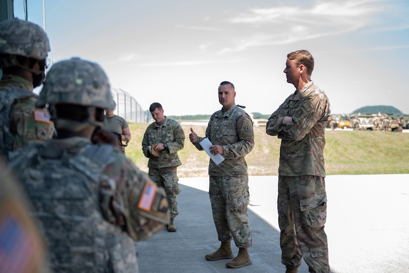 U.S. Army Maj. Christopher Fields (center), commander of the 690th Rapid Port Opening Element, briefs incoming soldiers who will support a Joint Task Force-Port Opening exercise known as Operation Lone Oak at Volk Field, Wis., June 7, 2021. The soldiers are from Fort Eustis, Va., which is home to the Army’s three RPOE units. (U.S. Air National Guard photo by Senior Master Sgt. Vicky Spesard)