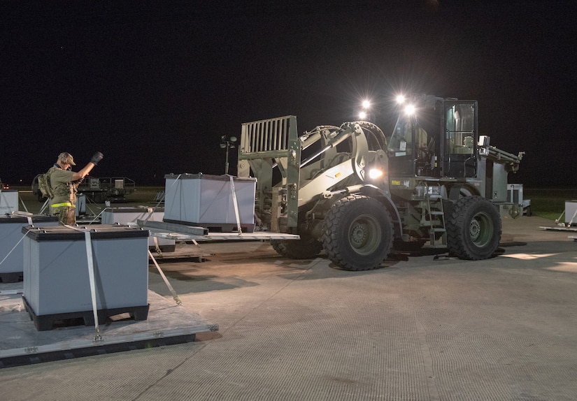 Aerial Porters from the Kentucky Air National Guard’s 123rd Contingency Response Group move cargo 24 hours a day during Operation Lone Oak at Volk Field, Wis., June 10, 2021 as part of a Joint Task Force-Port Opening. The objective of the JTF-PO is to establish a complete air logistics hub and surface distribution network. (U.S. Air National Guard photo by Senior Master Sgt. Vicky Spesard)