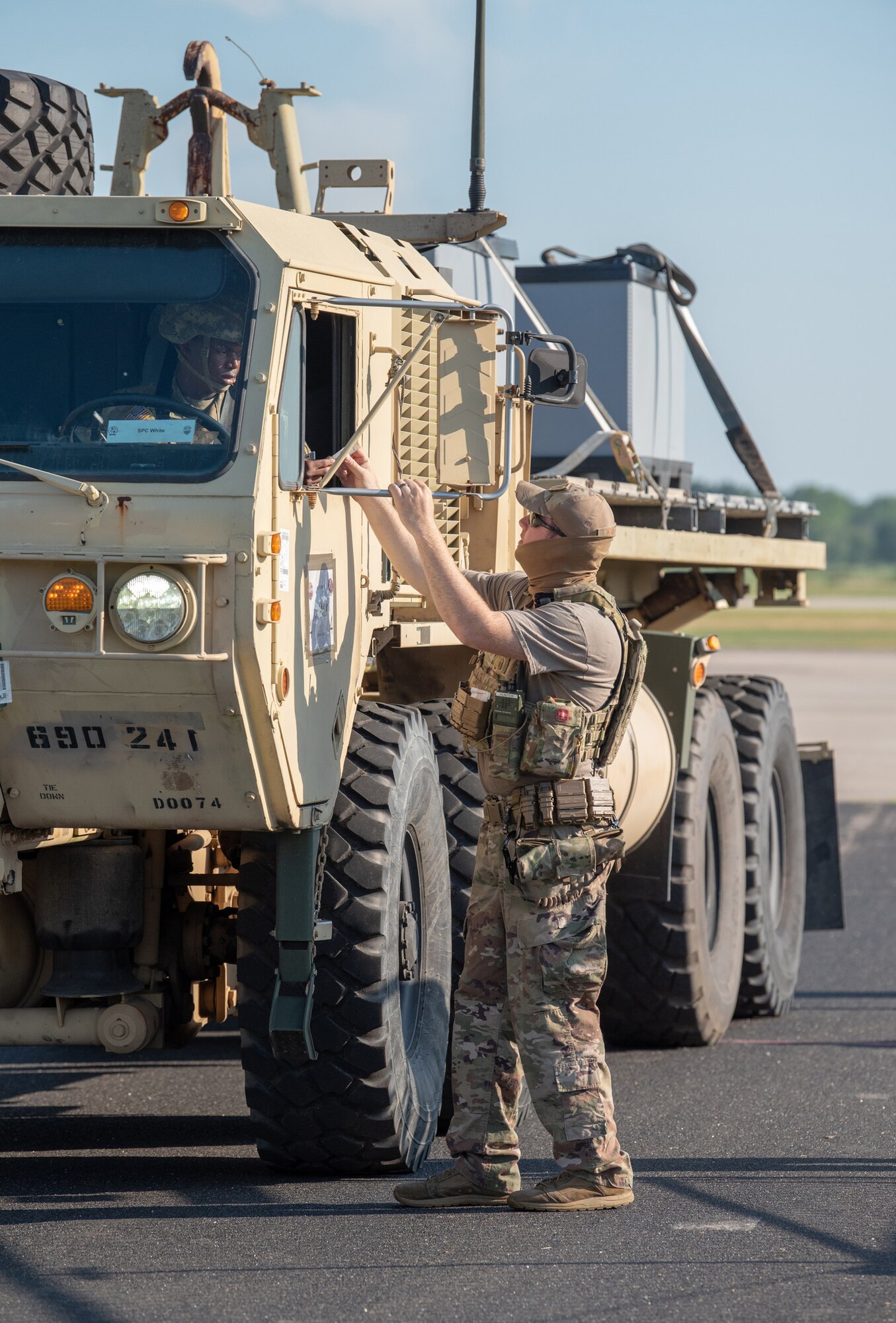 Staff Sgt. Chandler Hunter, a security forces specialist from the Kentucky Air National Guard’s 123rd Contingency Response Group, checks a U.S. Army cargo carrier through the gate during a Joint Task Force-Port Opening exercise known as Operation Lone Oak at Volk Field, Wis., June 11, 2021. The cargo movement was part of everyday operations during the JFT-PO exercise, which combined the efforts of the CRG with the U.S. Army’s 690th Rapid Port Opening Element from Fort Eustis, Va. The objective of a JTF-PO is to establish a complete air logistics hub and surface distribution network. (U.S. Air National Guard photo by Senior Master Sgt. Vicky Spesard)