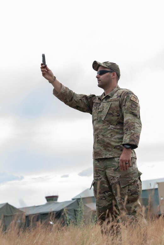 Staff Sgt. Alexander Klosterman, a weather specialist with the Kentucky Air National Guard’s 123rd Contingency Response Group, takes wind measurements for airfield operations during a Joint Task Force-Port Opening exercise known as Operation Lone Oak at Volk Field, Wis., June 11, 2021. (U.S. Air National Guard photo by Senior Master Sgt. Vicky Spesard)