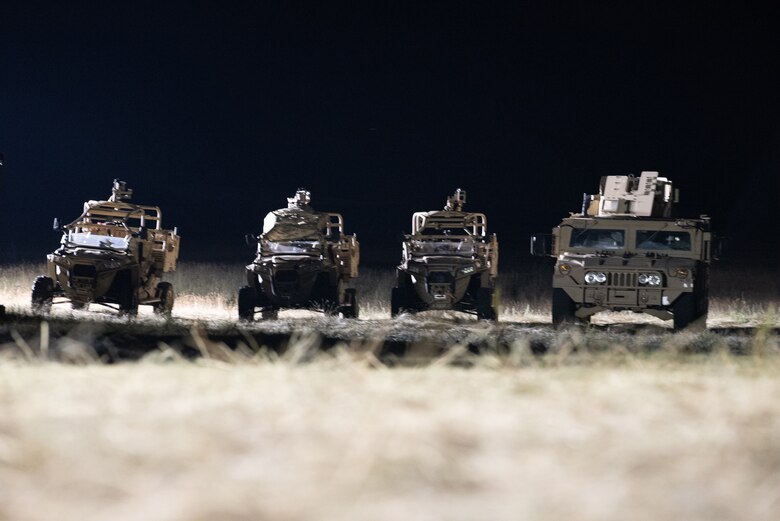 Vehicles from the Kentucky Air National Guard’s 123rd Contingency Response Group security forces stand ready in the night during Operation Lone Oak at Volk Field, Wis., June 10, 2021. The 123rd CRG worked in conjunction with the U.S. Army’s 690th Rapid Port Opening Element to operate a Joint Task Force-Port Opening during the exercise. The objective of a JTF-PO is to establish a complete air logistics hub and surface distribution network. (U.S. Air National Guard photo by Senior Master Sgt. Vicky Spesard)