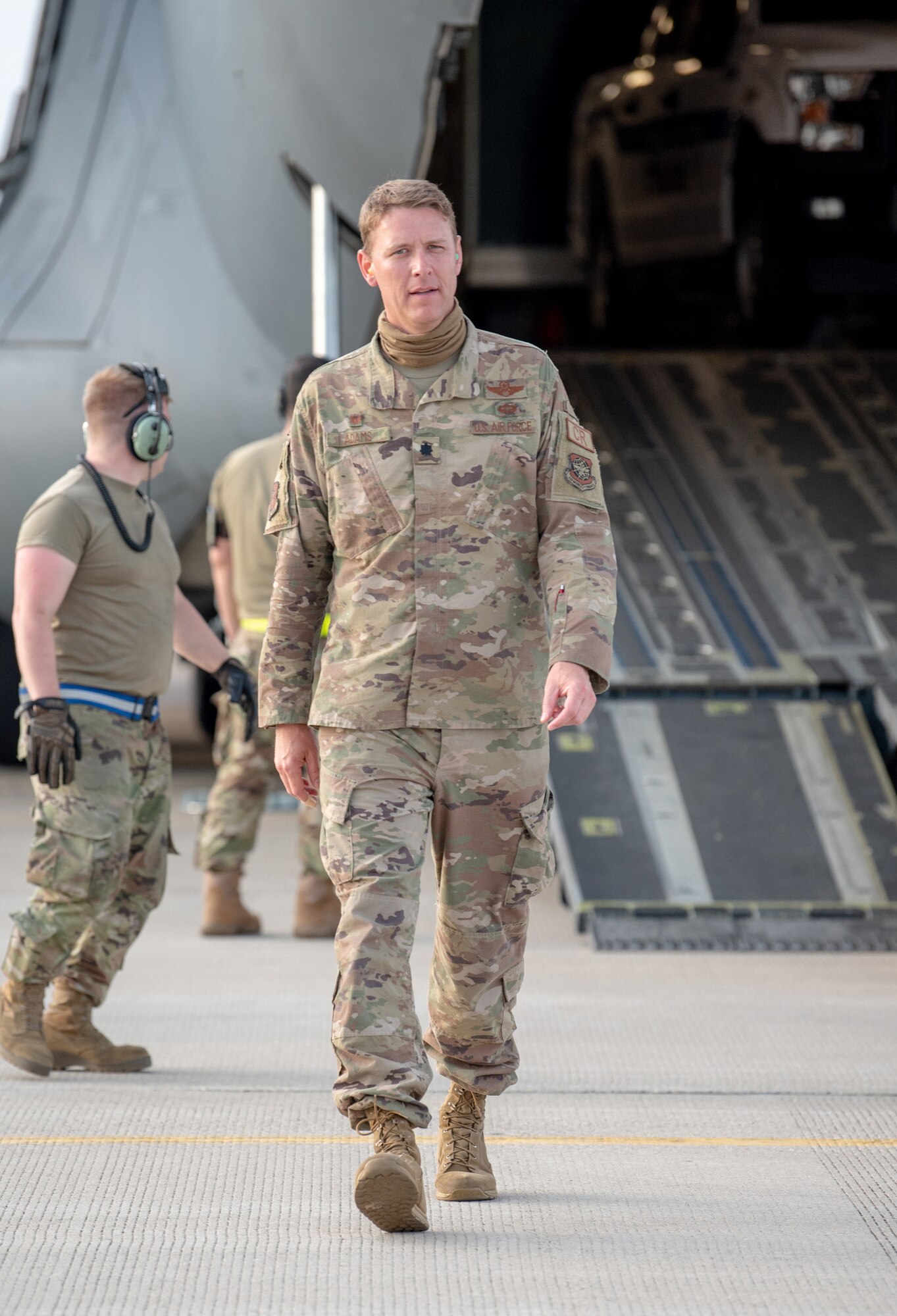 Lt. Col. Ryan Adams of the Kentucky Air National Guard’s 123rd Contingency Response Group observes cargo off-loading procedures by CRG aerial porters at Volk Field, Wis., June 11, 2021, during a Joint Task Force-Port Opening exercise known as Operation Lone Oak. Adams served as JTF-PO commander for the exercise, which tasked participants with establishing a complete air logistics hub and surface distribution network from scratch. (U.S. Air National Guard photo by Senior Master Sgt. Vicky Spesard)