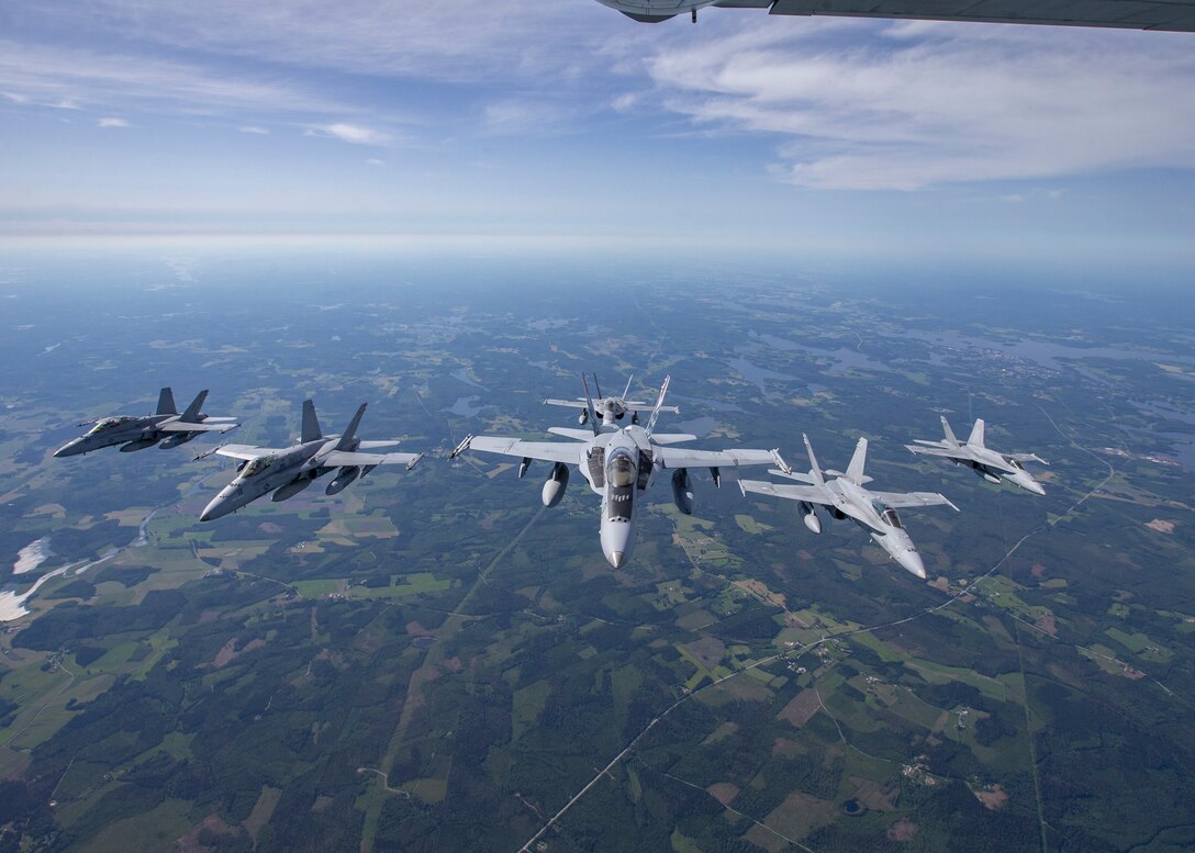 U.S. Marines with Marine Fighter Attack Squadron (VMFA) 115 fly alongside Finnish Air Force Fighter Squadron 31 over Rissala Air Base, near Kuopio, Finland, June 18, 2021. Marines with VMFA-115 are deployed to Kuopio, Finland in support of Squadron Visit ILVES (Finnish for “Lynx”). The purpose of Squadron Visit ILVES is to conduct air-to-air and air-to-ground training, improve proficiency in joint and multinational tactics, and enhance partnerships with international allies. VMFA-115 is a subordinate unit of 2nd Marine Aircraft Wing, the aviation combat element of II Marine Expeditionary Force. (U.S. Marine Corps photo by Lance Cpl. Caleb Stelter)