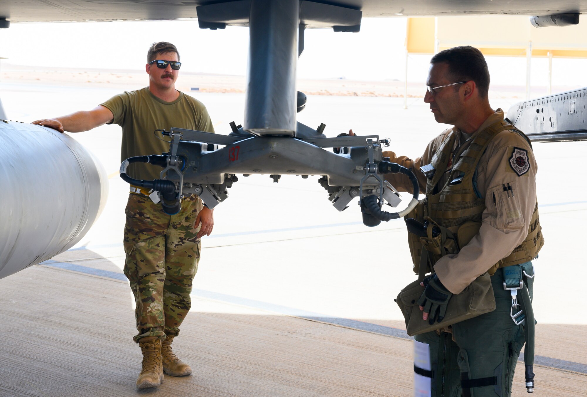 U.S. Air Force Brig. Gen. Robert Davis, 378th Air Expeditionary Wing commander, conducts a pre-flight inspections with U.S. Air Force Senior Airman Ryan West, 157th Expeditionary Fighter Generation Squadron F-16 crew chief, prior to the general’s flight in a U.S. Air Force F-16 Fighting Falcon, Prince Sultan Air Base, Kingdom of Saudi Arabia, June 20, 2021. Davis, a trained fighter pilot, flew a sortie with the 157th Expeditionary Fighter Squadron, currently deployed to PSAB to bolster defensive capabilities against potential threats in the region. (U.S. Air Force photo by Senior Airman Samuel Earick)