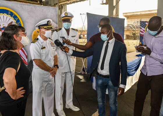 (JUNE 23, 2021) Capt. Michael Concannon, commanding officer, gold crew, left, and Senegalese navy Capt. Ibrahima Sow speak with local media outlets during a tour of the ship aboard the Expeditionary Sea Base USS Hershel “Woody” Williams (ESB 4) in Dakar, Senegal, June 23, 2021. Hershel “Woody” Williams is on a scheduled deployment in the U.S. Sixth Fleet area of operations in support of U.S. national interests and security in Europe and Africa.