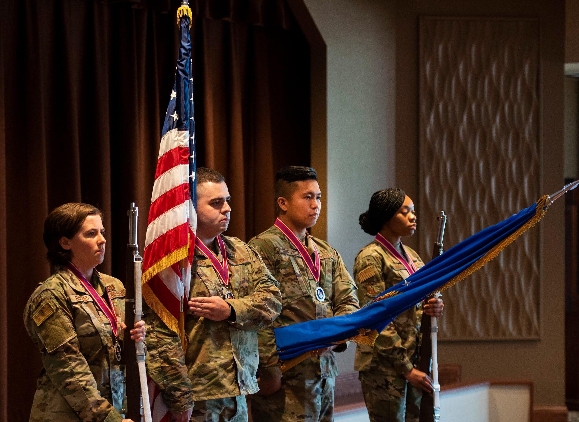 An honor guard made up of Airman Leadership School Class 21-E members posts colors at the start of their class graduation June 17, 2021, at Wright-Patterson Air Force Base, Ohio. The class of 23 junior Airmen was trained in the skills needed as they move into the NCO ranks. (U.S. Air Force photo by R.J. Oriez)