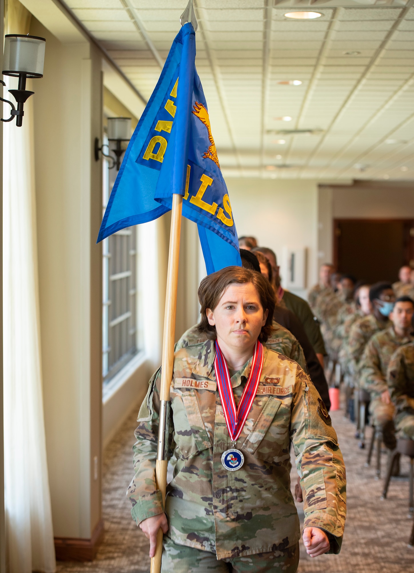 Senior Airman Chloe Holmes, U.S. Air Force Band of Flight, leads her Airman Leadership School class into its graduation ceremony June 12, 2021, at Wright-Patterson Air Force Base, Ohio. (U.S. Air Force photo by R.J. Oriez)