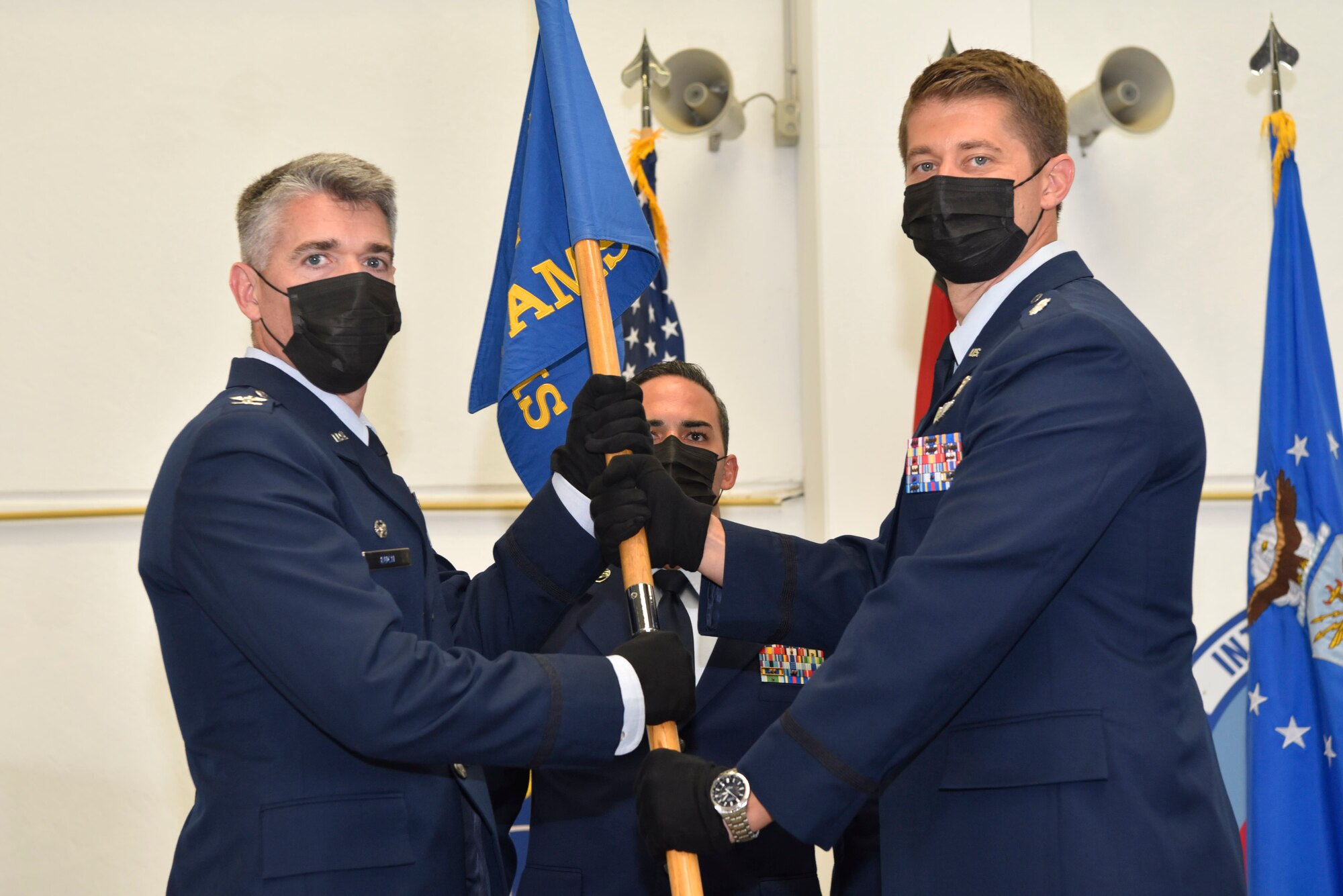 The 721st Air Mobility Operations Group commander gives the 726th Air Mobility Squadron guidon the new 726th AMS commander.