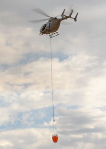 Members of the Nebraska National Guard's 1-376th Aviation Battalion practice water bucket training, May 15, 2021, near Camp Ripley in Little Falls, Minn. Two helicopter crews helped battle wildfires near Brush Creek in Nebraska June 24-25, 2021, dropping 23,000 gallons of water.