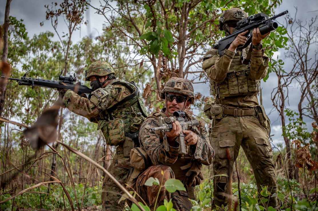 U.S. Marine Corps Lance Cpl. Hunter Johnson, a gunner with Weapons Company, 1st Battalion, 7th Marine Regiment, Marine Rotational Force – Darwin, center; Sgt. 1st Class Akito Yagi, a sniper with 50th Infantry Regiment, Japan Ground Self-Defense Force, left; and Australian Army Pvt. Lochlan Bryden, a rifleman with Bravo Company, 5th Battalion, Royal Australian Regiment, assume a tactical position during the closing ceremony of exercise Southern Jackaroo at Mount Bundey Training Area, NT, Australia, June 24, 2021. U.S. Marines, Australian Army soldiers and JGSDF soldiers commemorated the completion of exercise Southern Jackaroo with a closing ceremony. Defense ties between the United States, allies and partner nations are critical to regional security, cooperation and integration of our combined capabilities.