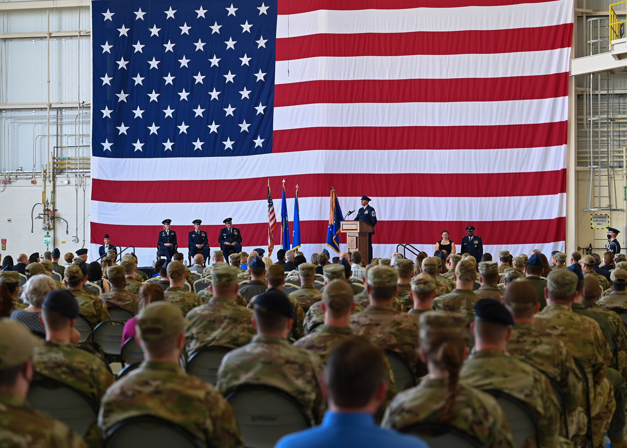 Airmen and attendees look on before the start of a change of command ceremony.