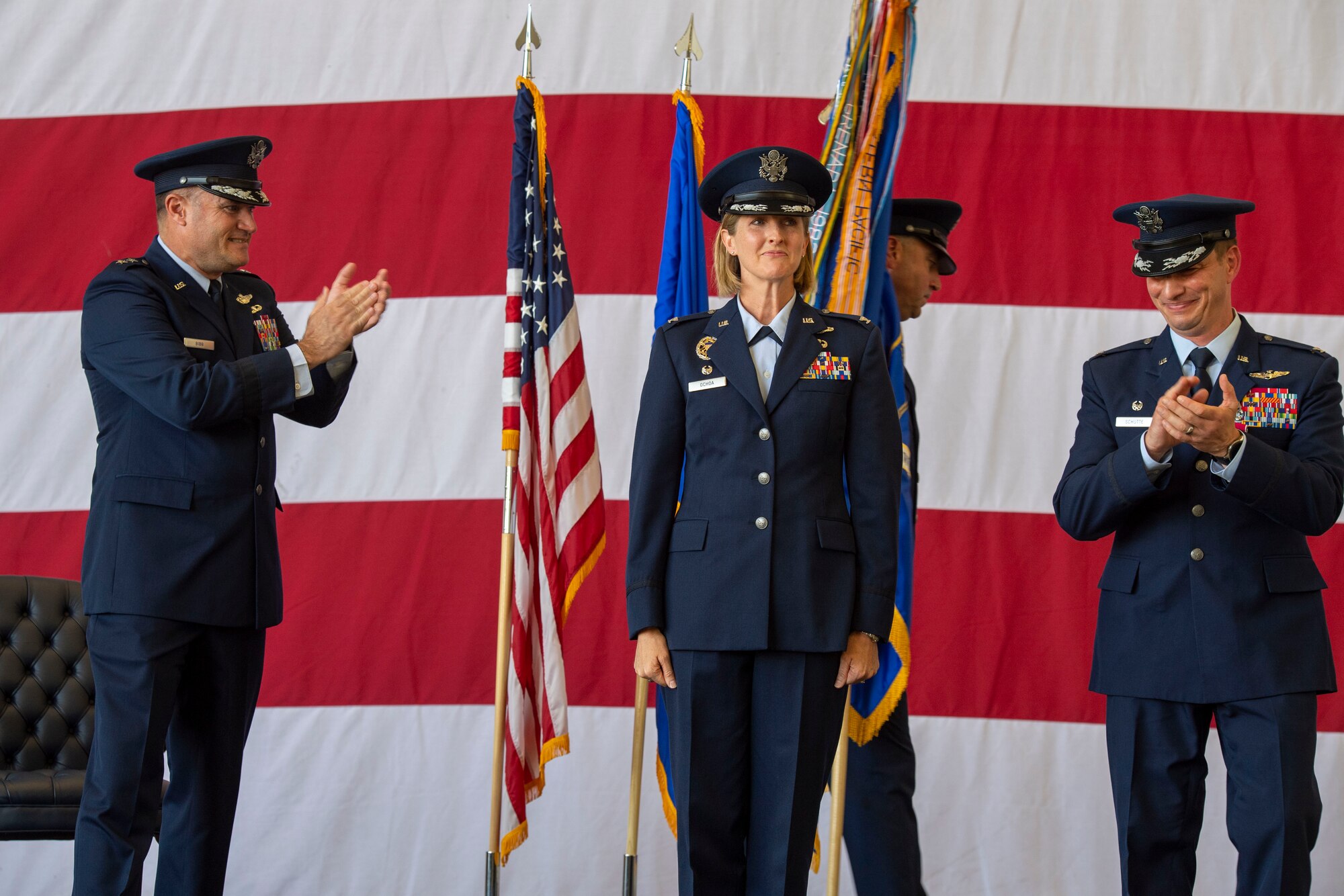 Airmen congratulate a new leader during a change of command ceremony.