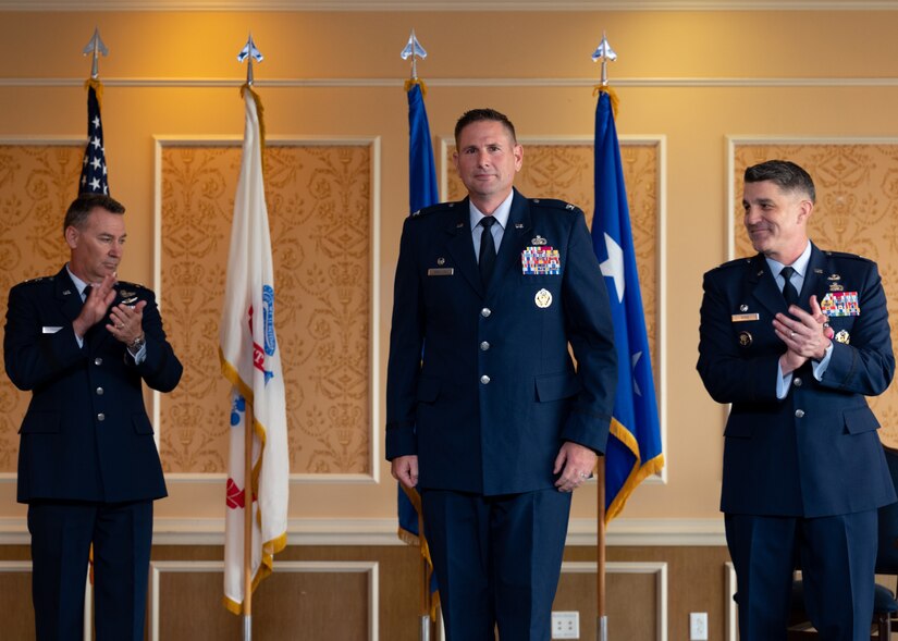 U.S. Air Force Maj. Gen. Chad P. Franks, 15th Air Force commander, and U.S. Air Force Col. Clint Ross, outgoing 633d Air Base Wing commander, applaud U.S. Air Force Col. Gregory Beaulieu, incoming 633d Air Base Wing commander, during a change of command ceremony on June 25, 2021 at Joint Base Langley Eustis. Beaulieu previously served as the Commander of the 325th Mission Support Group, 325th Fighter Wing, Air Combat Command, Tyndall Air Force Base, Florida.