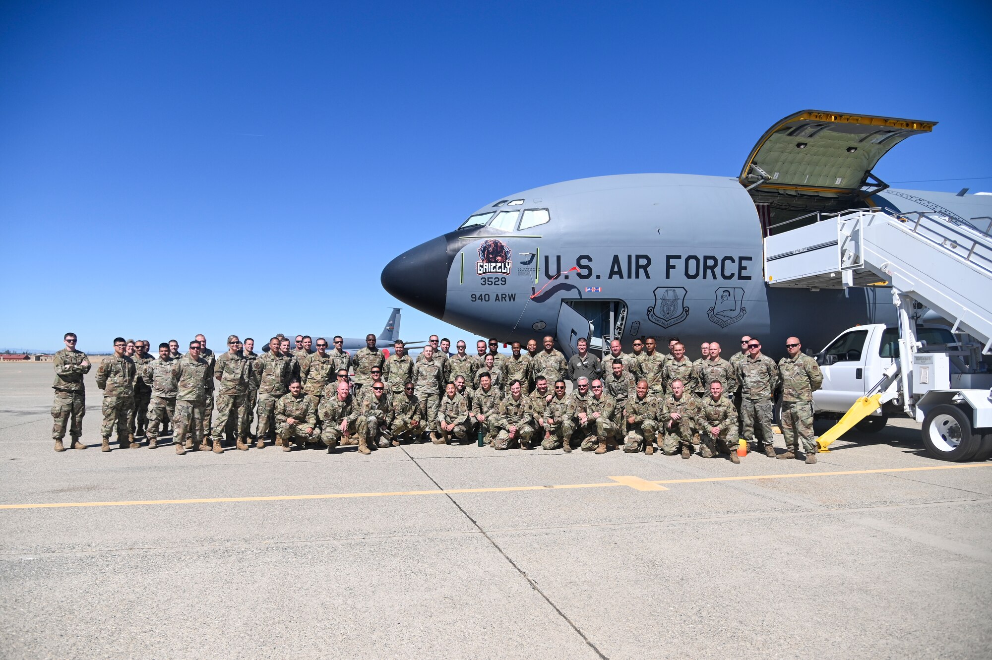 Airmen from the 940th Air Refueling Wing, Fourth Air Force and Air Force Reserve Command pose with the unit’s newest KC-135 Stratotanker nose art, "Grizzly," June 13, 2021, at Beale Air Force Base, California.
