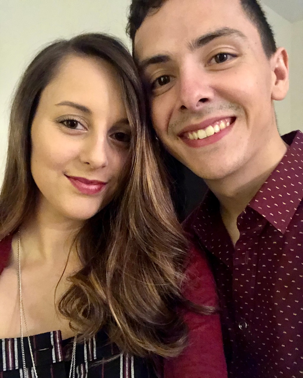 Two people smile for a photo.