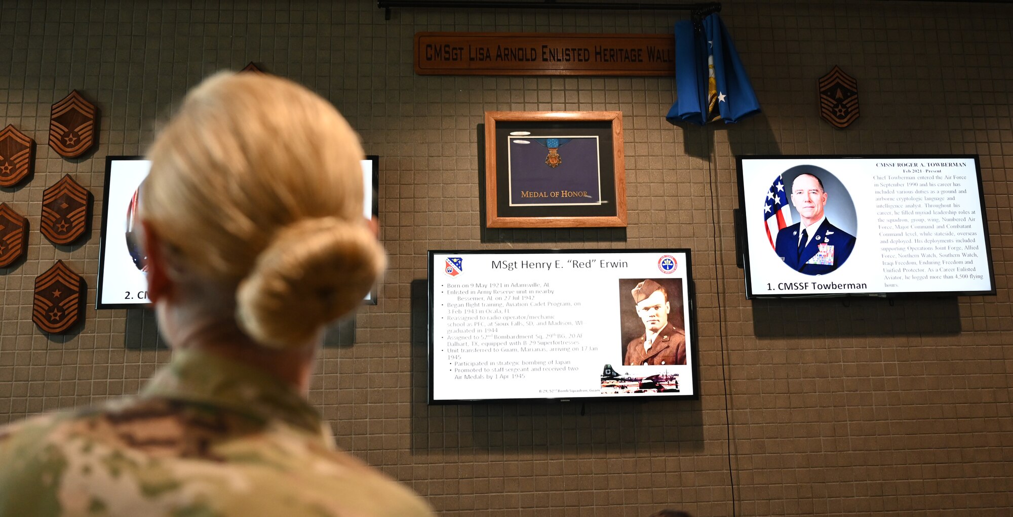 Chief Master Sgt. Lisa A. Arnold, Space and Missile Systems Center Command Chief, looks at the newly unveiled Enlisted Heritage wall at the South Bay Bar and Grill on Los Angeles Air Force Base, Calif., June 24, 2021. The wall is titled "CMSgt Lisa Arnold Enlisted Heritage Wall" after the current Space and Missile Systems Center's Command Chief Master Sgt. Lisa A. Arnold who will be the last U.S. Air Force command chief for Los Angeles AFB before being replaced by a U.S. Space Force Senior Enlisted Leader. (U.S. Space Force photo by Staff Sgt. Elijah Jackson)