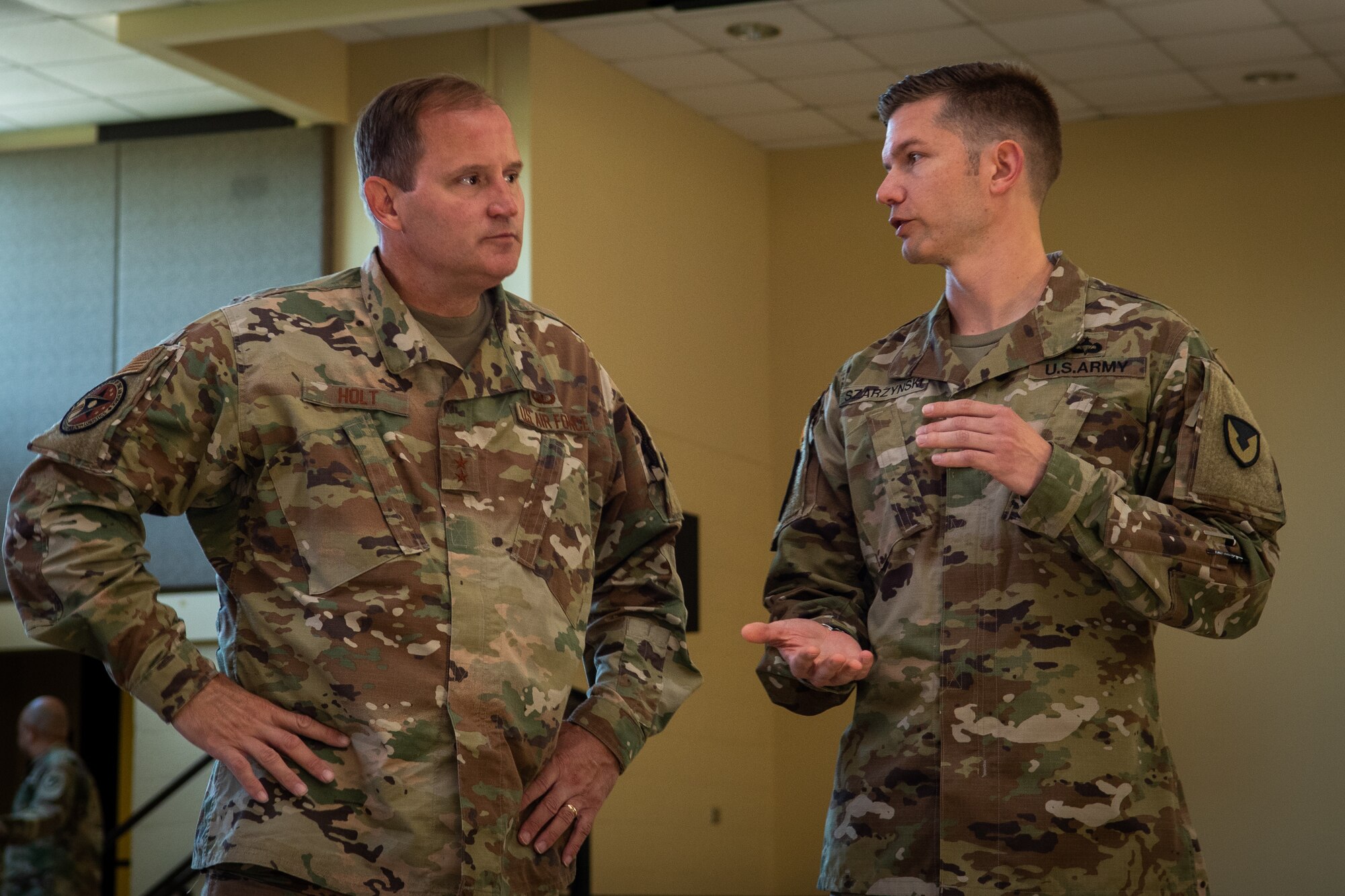 Army Maj. Matthew Szarzynski, right, 419th Contracting Support Brigade contracting officer speaks with Air Force Maj. Gen. Cameron Holt, Deputy Secretary for Contracting, Office of the Assistant Secretary of the Air Force for Acquisition, Technology and Logistics, at Fort Bragg, North Carolina, June 24, 2021. Holt visited the exercise and briefed airmen and soldiers on the benefits of working in a joint environment for training exercises. (U.S. Air Force photo by Airman 1st Class David Lynn)