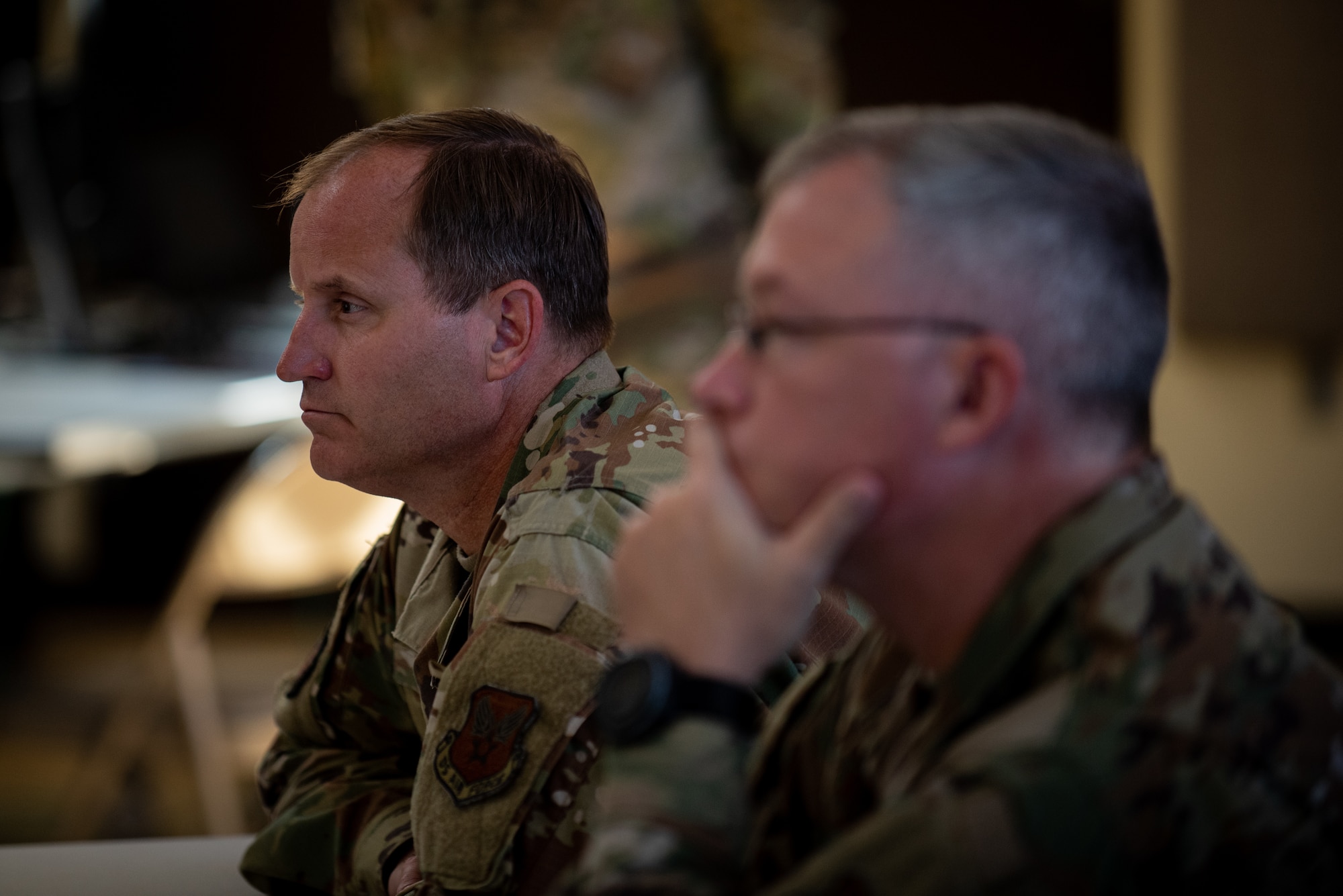 Air Force Maj. Gen. Cameron Holt, back, Deputy Secretary for Contracting, Office of the Assistant Secretary of the Air Force for Acquisition, Technology and Logistics, and Chief Master Sgt. Dennis Carr, Contracting Career Field Manager and Chief of Enlisted Policy, receive a brief at Fort Bragg, North Carolina, June 24, 2021. The brief was part of Joint Forces Contracting Exercise 2021.