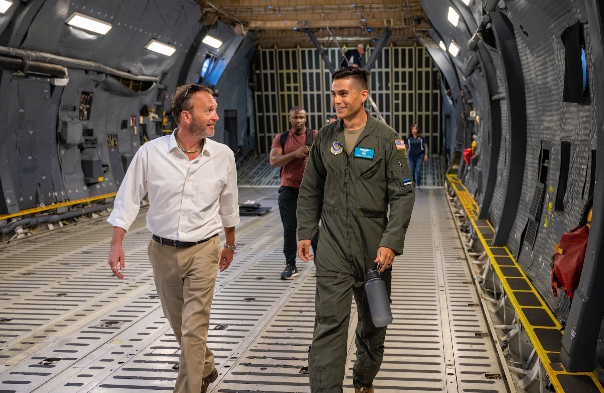Todd Stonesifer, left, Dover Air Force Base honorary commander, talks to 1st Lt. Jordan Coaliron, 9th Airlift Squadron pilot, while walking in the cargo deck of a C-5M Super Galaxy at Dover AFB, Delaware, June 23, 2021. The Dover AFB honorary commanders program encourages an exchange of ideas, experiences and friendships between key members of the local community and Dover AFB. (U.S. Air Force photos by Senior Airman Faith Schaefer)