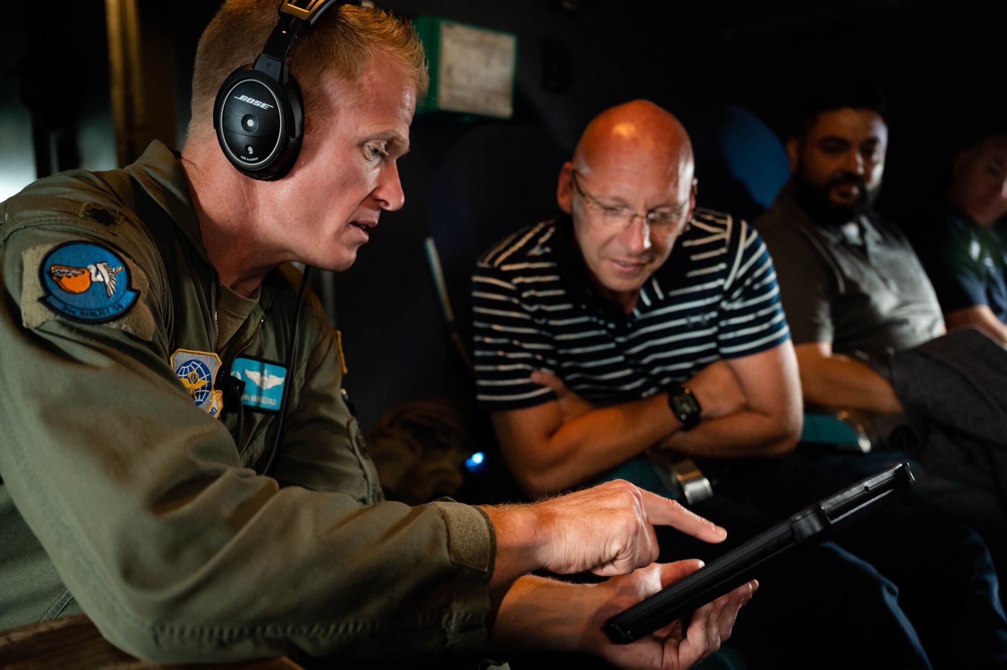 Lt. Col. John Habbestad, left, 9th Airlift Squadron commander, explains the flight path of an incentive flight to Jason Payne, Dover Air Force Base honorary commander, aboard a C-5M Super Galaxy over Delaware, June 23, 2021. The Dover AFB honorary commanders program encourages an exchange of ideas, experiences and friendships between key members of the local community and Dover AFB. (U.S. Air Force photos by Senior Airman Faith Schaefer)