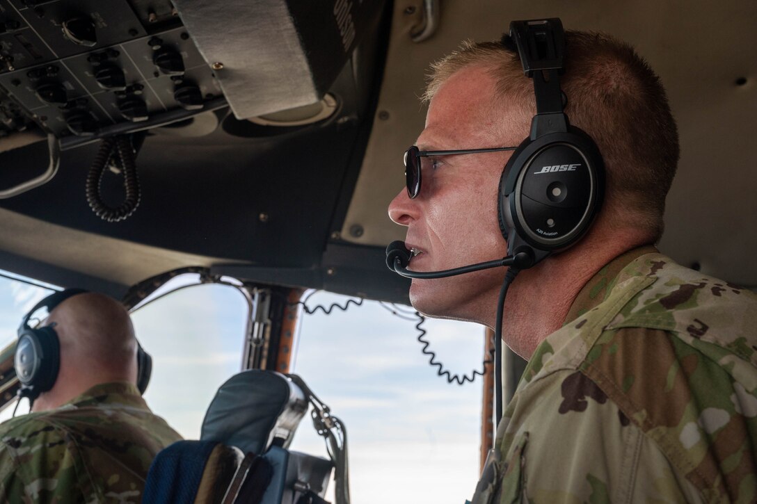 Lt. Col. John Habbestad, 9th Airlift Squadron commander, observes the surrounding airspace from the jump seat during a routine training flight on a C-5M Super Galaxy over California, June 5, 2021. During a Major Command Service Tail Trainer, pilots and flight engineers were able to fly over the West Coast using visual flight rules. This requires crew members to use ground references to fly, exercising different skill sets not often used in day-to-day operations. (U.S. Air Force photo by Senior Airman Faith Schaefer)