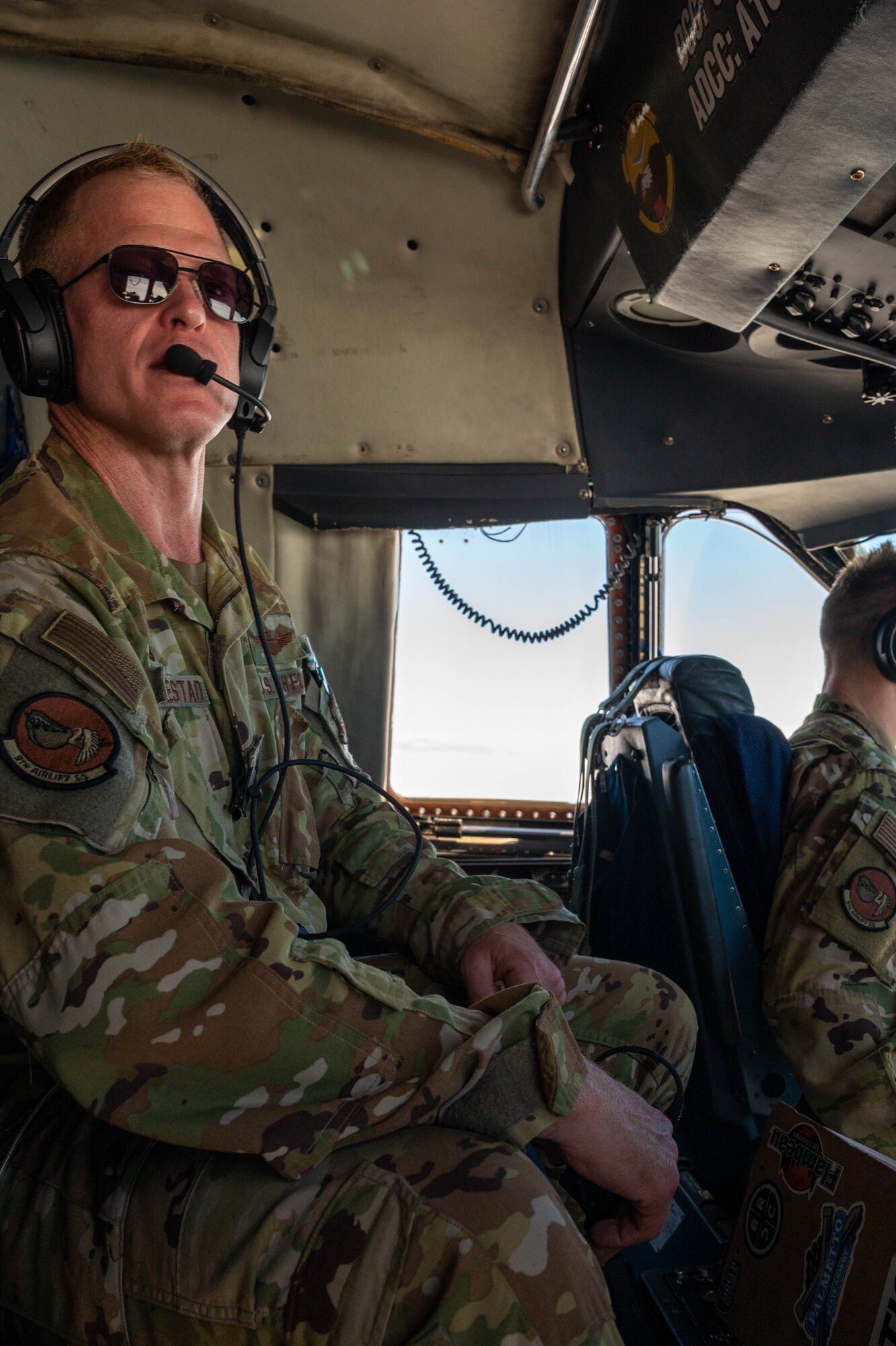 Lt. Col. John Habbestad, 9th Airlift Squadron commander, observes the surrounding airspace from jump seat during a routine training flight on a Dover Air Force Base C-5M Super Galaxy, over California, June 5, 2021. During a Major Command Service Tail Trainer, pilots and flight engineers were able to fly over the West Coast using visual flight rules. This requires crew members to use ground references to fly, exercising different skill sets not often used in day-to-day operations. (U.S. Air Force photo by Senior Airman Faith Schaefer)