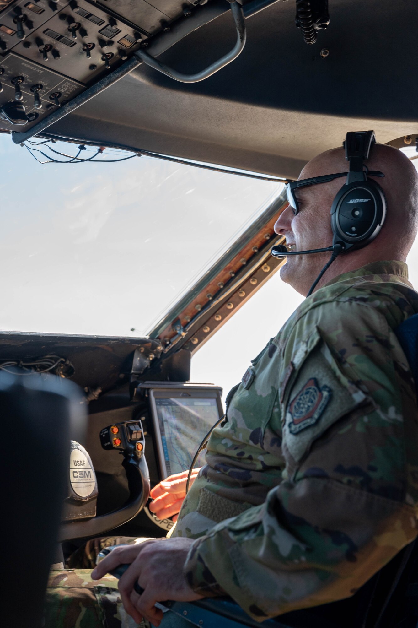 Capt. Dustin Suire, 9th Airlift Squadron pilot, discusses a flight plan as he flies a Dover Air Force Base C-5M Super Galaxy during a routine training flight over California, June 5, 2021. During a Major Command Service Tail Trainer, pilots and flight engineers were able to fly over the West Coast using visual flight rules. This requires crew members to use ground references to fly, exercising different skill sets not often used in day-to-day operations. (U.S. Air Force photo by Senior Airman Faith Schaefer)