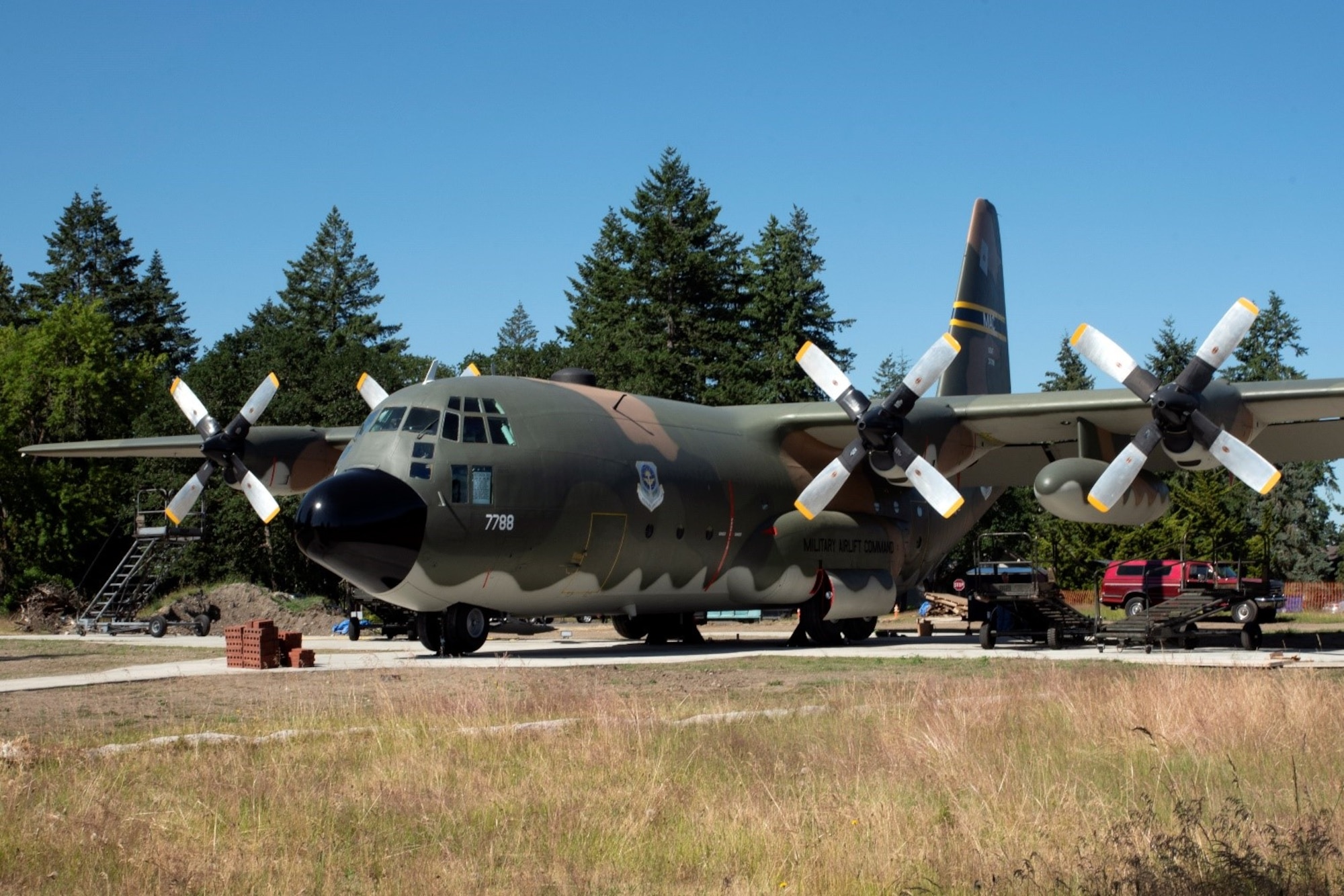 The 62nd Aircraft Maintenance Squadron, along with several other Team McChord units, towed a C-130E Hercules to its display area on Heritage Hill at Joint Base Lewis-McChord, Washington, June 23, 2021. The units worked together in order to coordinate and carry out the successful removal of the C-130’s wings, engine, fuel tanks, lower antennas and landing gear doors so the aircraft could be towed down the McChord Field flightline and put on display after restoration. The C-130 was restored by volunteers and will be the newest addition to the aircraft of McChord Air Museum on Heritage Hill. (U.S. Air Force photo by Senior Airman Zoe Thacker)