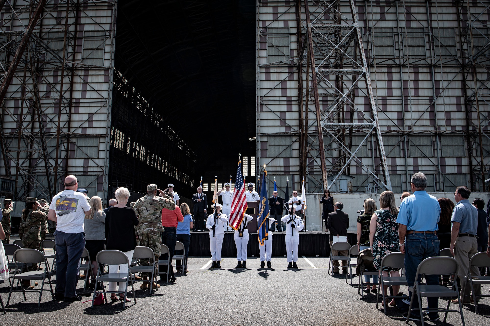 Photo of Naval Support Activity, Lakehurst, centennial attendees standing for the national anthem.