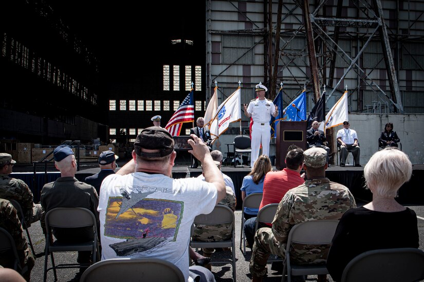 Photo of a Sailor speaking during a ceremony.