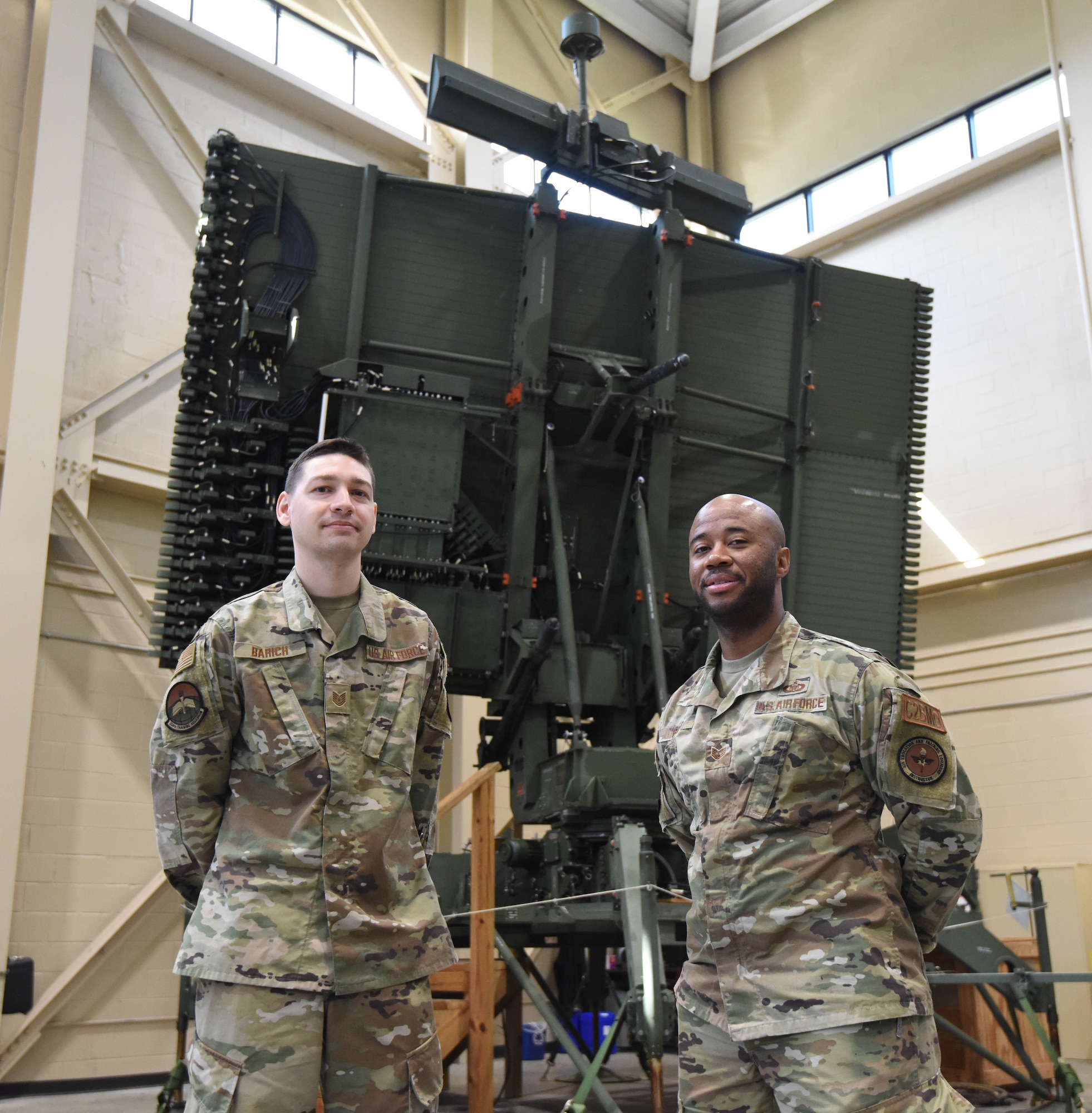 U.S. Air Force Tech. Sgts. Joshua Barich and Staff Sgt. Kevin Boyd, 334th Training Squadron Command and Control Battle Management Operations apprentice course instructors, pose for a photo inside Matero Hall at Keesler Air Force Base, Mississippi, June 24, 2021. The radar is used by C2BMOs to provide safe use of the airspace by tracking aircraft, planning missions, and monitoring the skies. (U.S. Air Force photo by Airman 1st Class Jasmine Galloway)