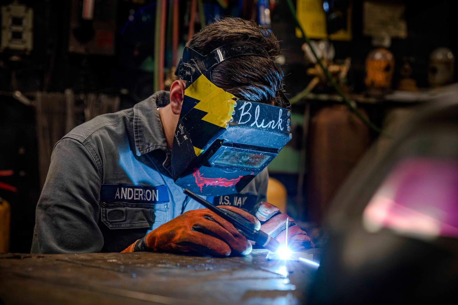 210617-N-IK871-2016 ATLANTIC OCEAN (June 17, 2021) Fireman Anderson practices tig welding using a tig torch aboard the Wasp-class amphibious assault ship USS Kearsarge (LHD 3) June 17, 2021. Anderson was the Commander Naval Surface Force Atlantic Surface Line Week welding competition winner by showcasing skills as a hull technician by welding a command representation piece using repair equipment on board Kearsarge. (U.S. Navy photo by Mass Communication Specialist Class 3rd Nick Boris)