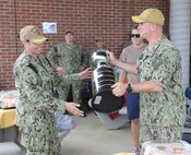 NAVAL STATION NORFOLK (June 25, 2021) Rear Adm. Brendan McLane, the commander of Naval Surface Force Atlantic (SURFLANT), presents the medium-command SURFLANT Surface Line Week (SLW) trophy to the Whidbey Island-class dock landing ship USS Whidbey Island (LSD 41). An annual competition hosted by Naval Surface Force Atlantic (SURFLANT) for all subordinate SURFLANT commands, SLW sees Hampton Roads-based service members from the Navy and Marine Corps unite to participate in camaraderie-building events and contests. (U.S. Navy photo by Mass Communication Specialist 2nd Class Jacob Milham/Released)