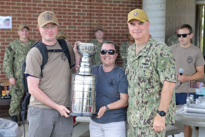 NAVAL STATION NORFOLK (June 25, 2021) Rear Adm. Brendan McLane, the commander of Naval Surface Force Atlantic (SURFLANT), presents the large-command SURFLANT Surface Line Week (SLW) trophy to the amphibious assault ship USS Wasp (LHD 1). An annual competition hosted by Naval Surface Force Atlantic (SURFLANT) for all subordinate SURFLANT commands, SLW sees Hampton Roads-based service members from the Navy and Marine Corps unite to participate in camaraderie-building events and contests. (U.S. Navy photo by Mass Communication Specialist 2nd Class Jacob Milham/Released)