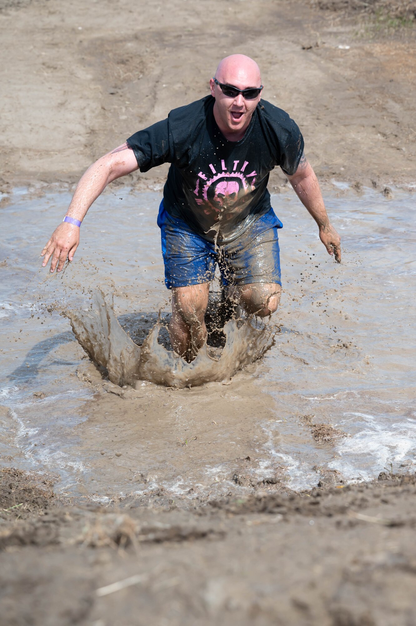 Staff Sgt. Justin Ferguson, 741st Maintenance Squadron maintainer, runs through a water obstacle during the Filthy Mudder race June 25, 2021, at Malmstrom Air Force Base, Mont.