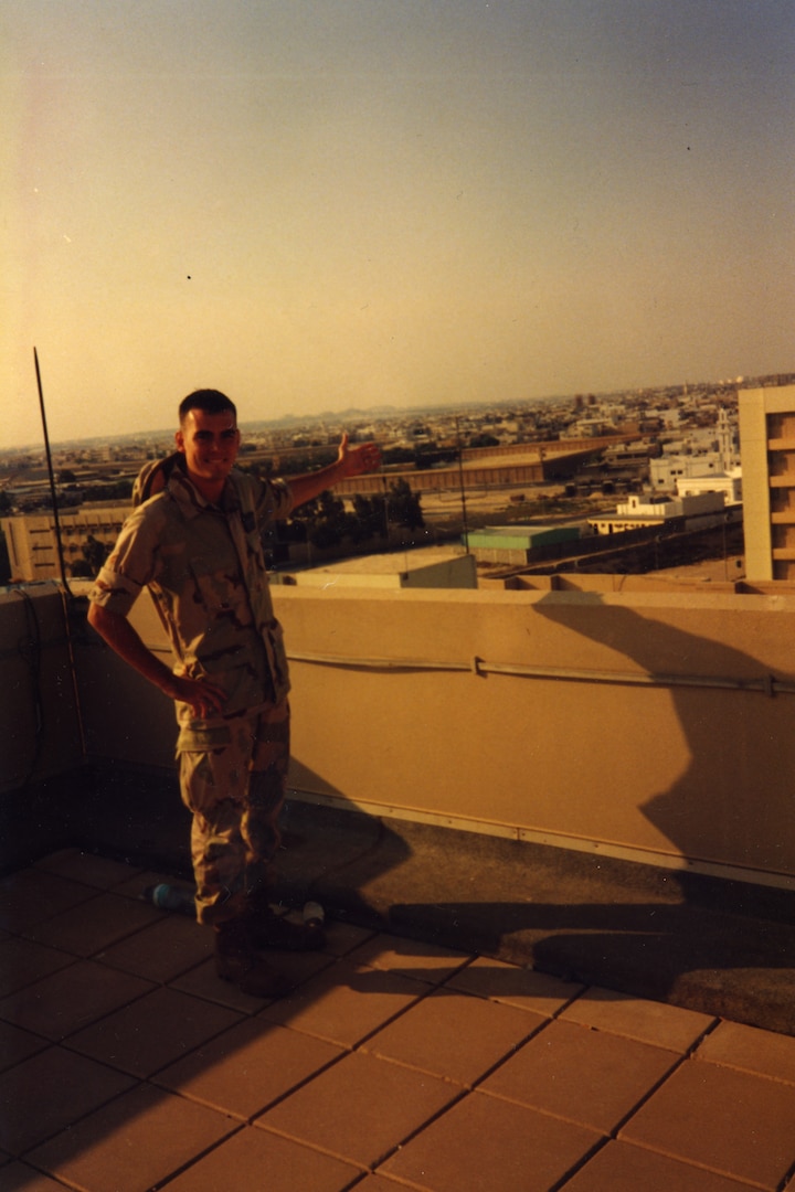 Then-Senior Airman Clifton Fulkerson poses on top of Building 131 of the Khobar Towers complex in Saudi Arabia, one week prior to terrorists detonating a truck bomb killing 19 US Air Force Airmen and wounding hundreds more. (Photo provided by Sergeant Major Clifton Fulkerson)