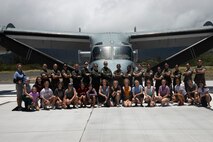 U.S. Marines with Marine Medium Tiltrotor Squadron 268 and Marine Heavy Helicopter Squadron 463, pose with a local all-girls group during a static display, Marine Corps Training Area Bellows, June 11, 2021. The purpose of the static display is to increase public awareness and understanding of the Marine Corps. (U.S. Marine Corps photo by Lance Cpl. Isaiah Hill)