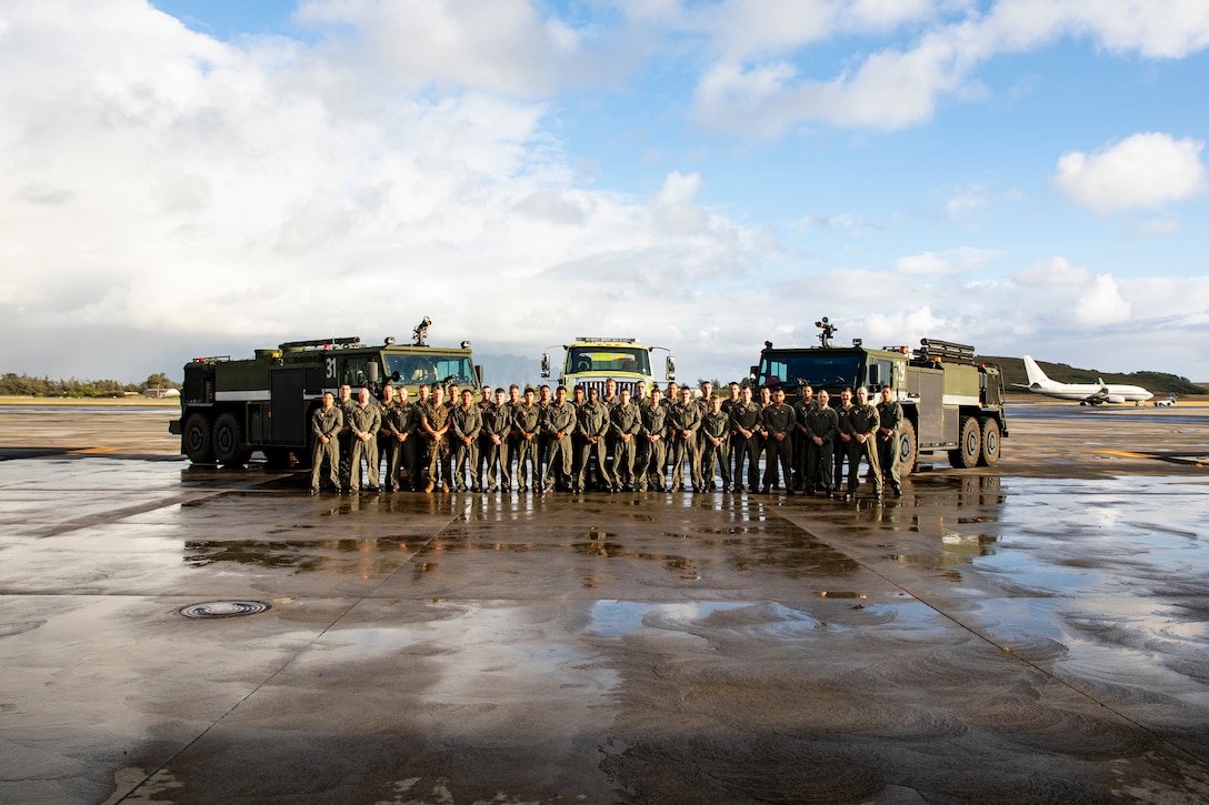 U.S. Marines attached to Aircraft Rescue and Firefighting pose for a photo aboard Marine Corps Air Station Kaneohe Bay, June 11, 2021. (U.S. Marine Corps photo by Lance Cpl. Samantha Sanchez)