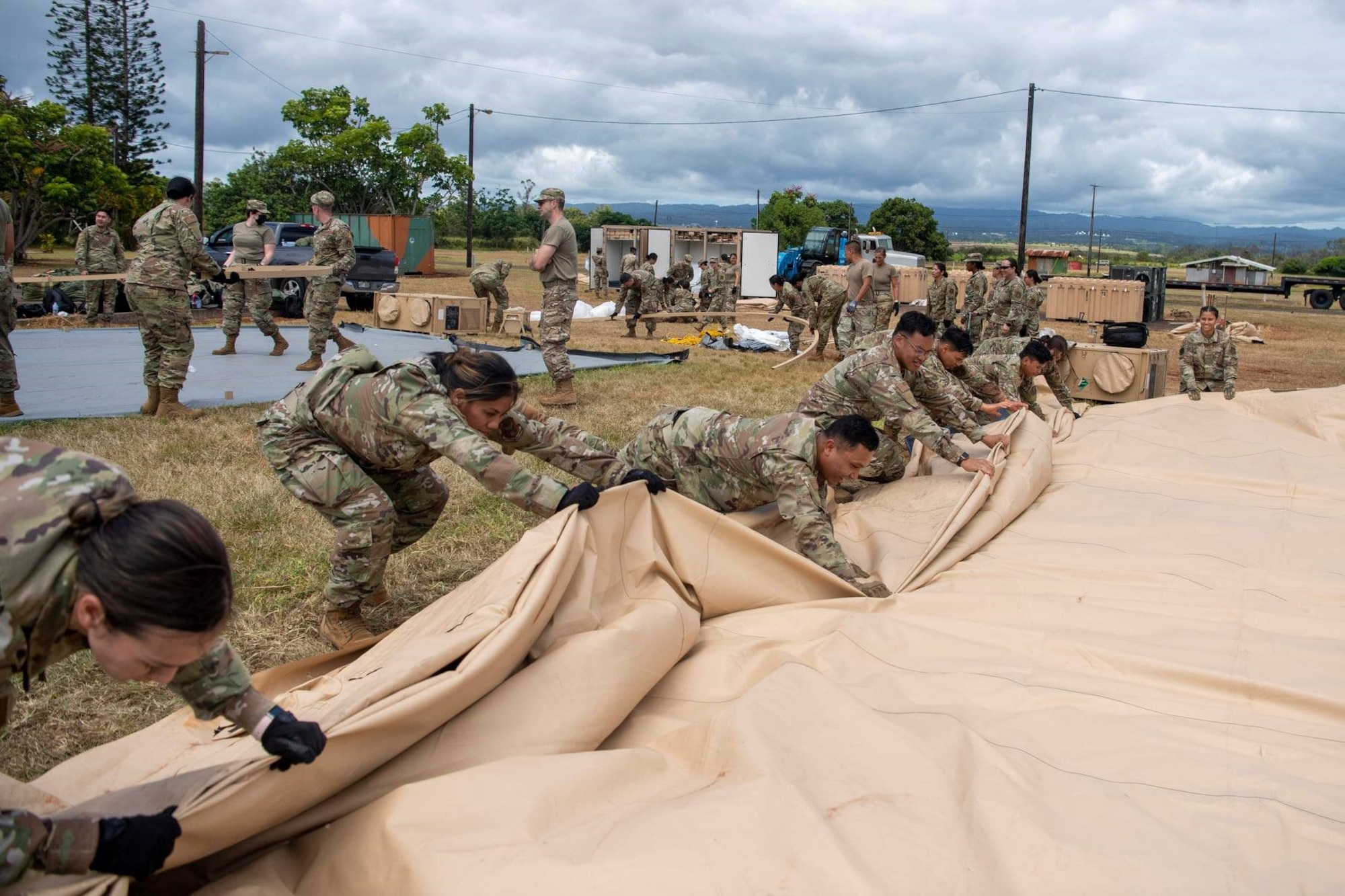 624th Regional Support Group Reserve Citizen Airmen break down Triple S construction tents after a Total Force Integration (TFI) exercise at Schofield Barracks, Hawaii. TFI is a blend of active, Guard, and Reserve personnel working together to accomplish the mission.
