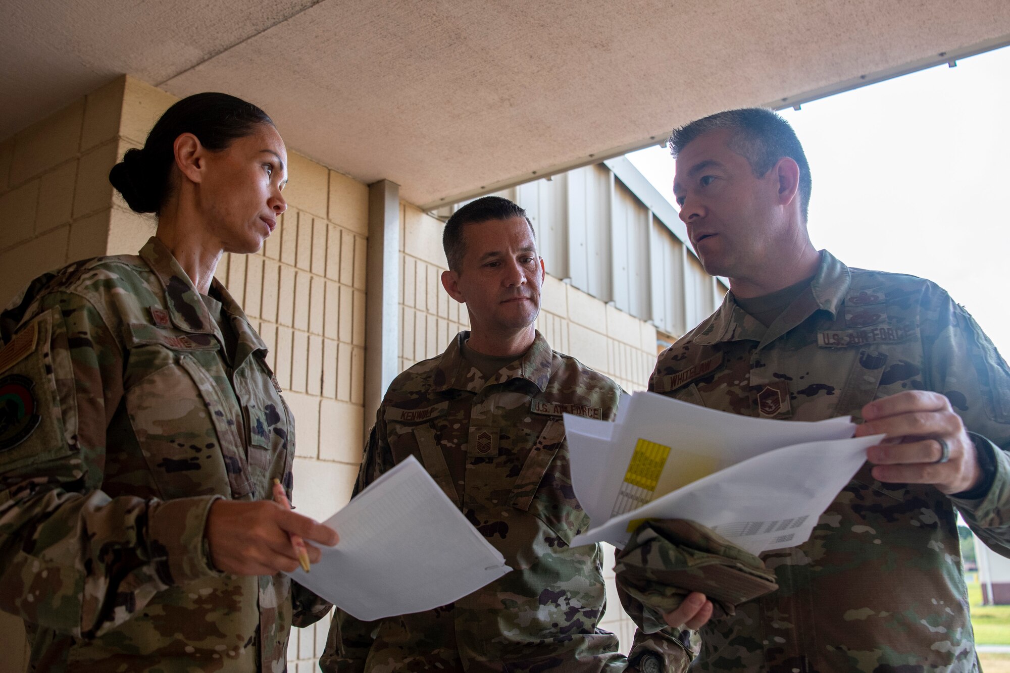 Lt. Col. Anjanette Lowe and Chief Master Sgt. James Kenwolf, 48th Aerial Port Squadron leadership, are briefed by Senior Master Sgt. Andrew Whitelaw on the different locations APS personnel will be located during a Total Force Integration and Joint Training exercise at Schofield Barracks, Hawaii June 13, 2021.