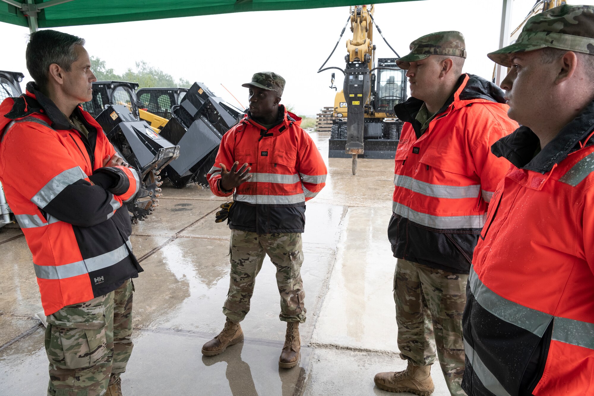 U.S. Air Force Tech. Sgt. Isaac Brenyah, 52nd Civil Engineer Squadron NCO in charge of Pavement and Equipment (center), and other Airmen from the 52nd Civil Engineer Squadron speak to U.S. Air Force Lt. Gen. Steven Basham, U.S. Air Forces in Europe and Air Forces Africa deputy commander.