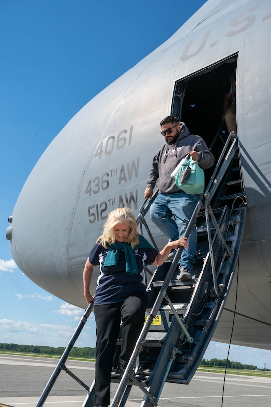 Janie Libby, bottom, and Tim Bailey, both Dover Air Force Base honorary commanders, exit a C-5M Super Galaxy after an incentive flight at Dover Air Force Base, Delaware, June 23, 2021. The Dover AFB honorary commanders program encourages an exchange of ideas, experiences and friendships between key members of the local community and Dover AFB. (U.S. Air Force photos by Senior Airman Faith Schaefer)