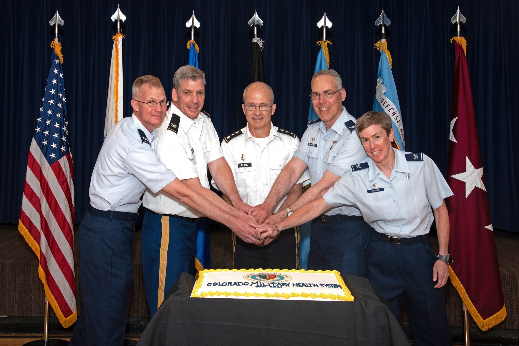 The Colorado Market establishment ceremony at Peterson Air Force Base, Colorado, on June 22, 2021, included a cake cutting with U.S. Air Force Col. Patrick Pohle, 21st Medical Group commander, left, U.S. Army Col. Kevin R. Bass, Evans Army Community Hospital commander and Colorado Market director; U.S. Army. Lt. Gen. (Dr.) Ronald J. Place, director of the Defense Health Agency; U.S. Air Force Col. Christopher Grussendorf, 10th Medical Group commander; and U.S. Air Force Col. Shannon Phares, 460th Medical Group commander.