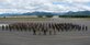 Participants of RED FLAG-Alaska stand together for a group on the flight line at Joint Base Elmendorf-Richardson, Alaska, on June 25, 2021 after completing the exercise. Approximately 1,500 service members are expected to fly, maintain and support more than 100 aircraft from more than 100 units during this iteration of the exercise. (U.S. Air Force photo by Alejandro Peña)